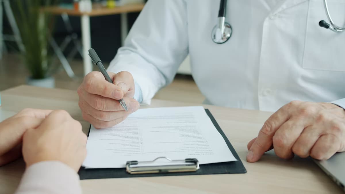 A doctor writing on a patient's chart during an appointment
